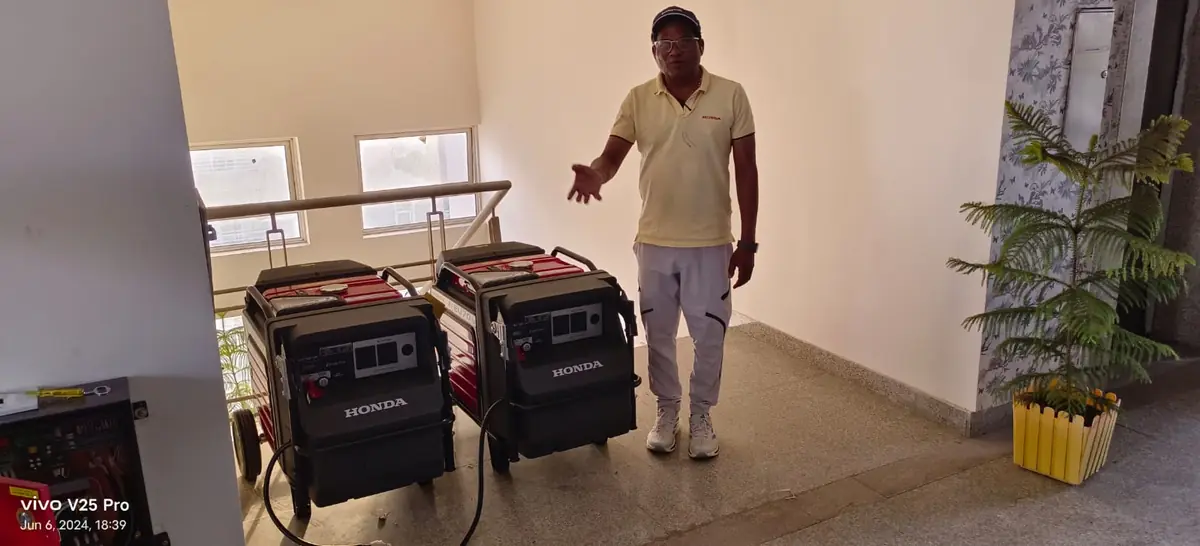 A customer with his two new Honda EU70is generators at home
